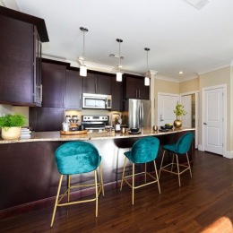 a kitchen with green chairs