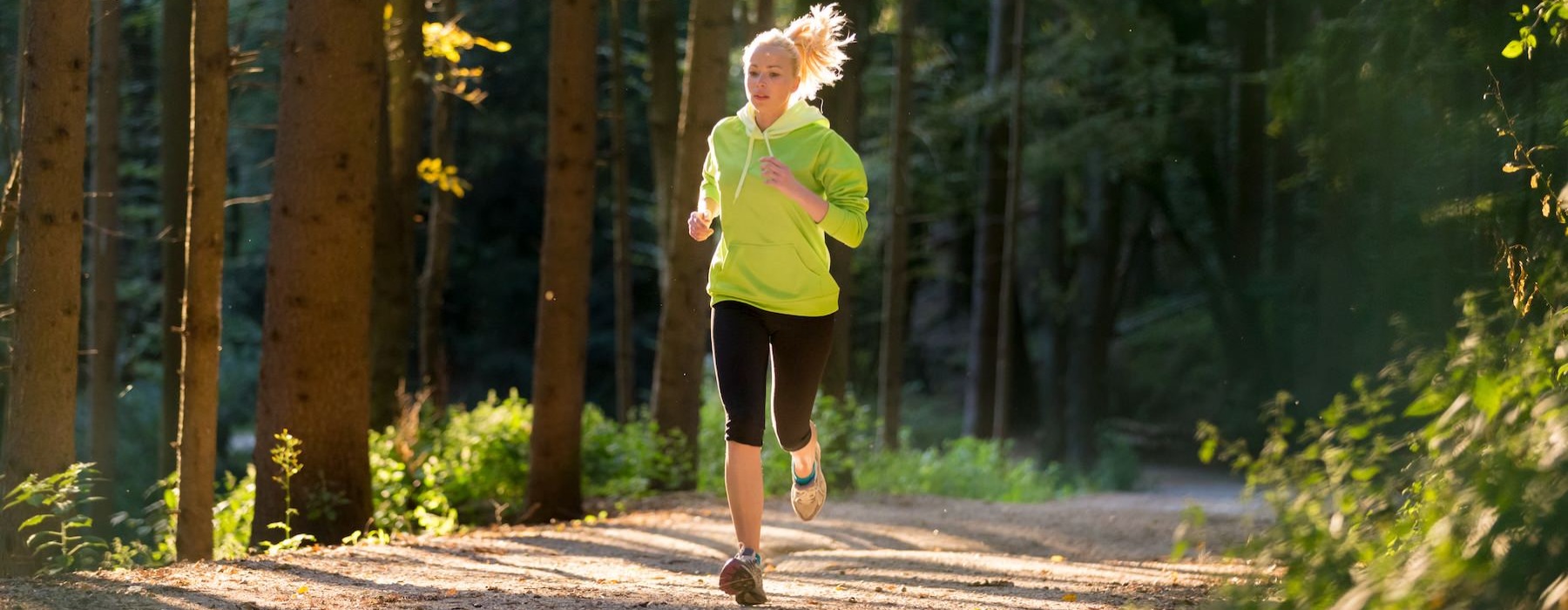 a person running on a path in the woods
