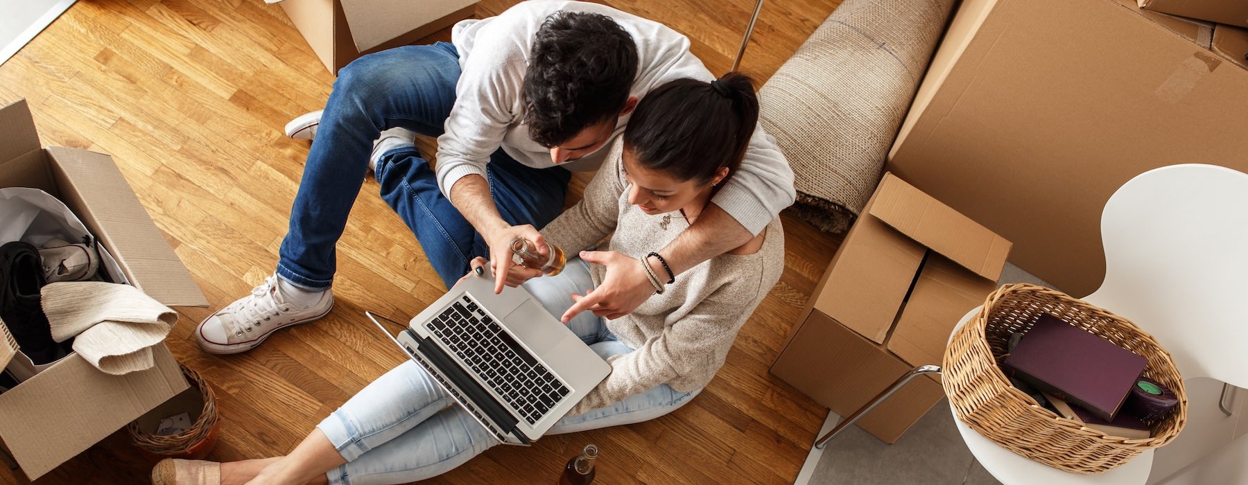 a man and woman looking at a laptop